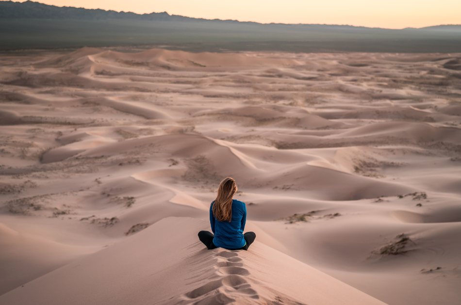 woman meditating in desert