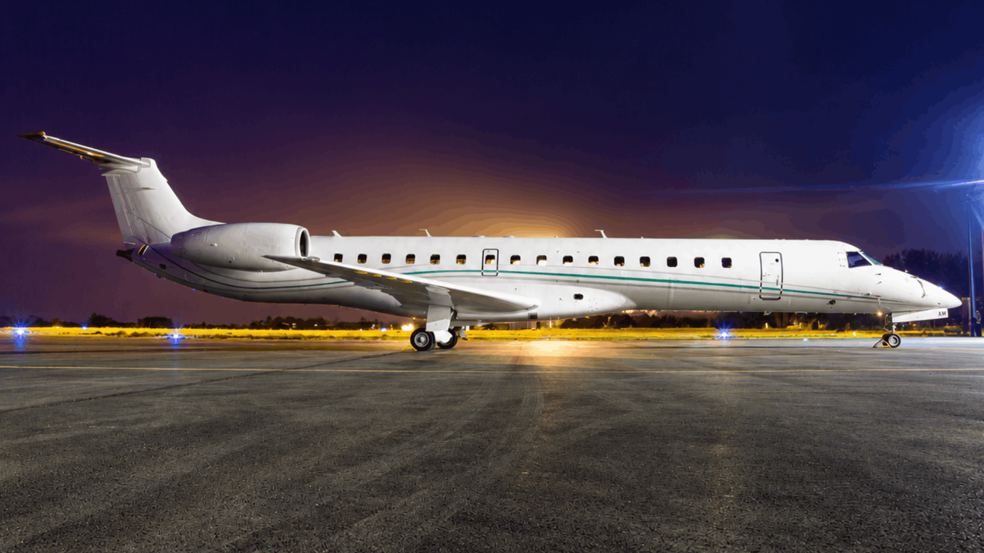 Private jet on tarmac at night