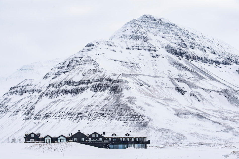 Deplar farm exterior of lodge against snowy mountain