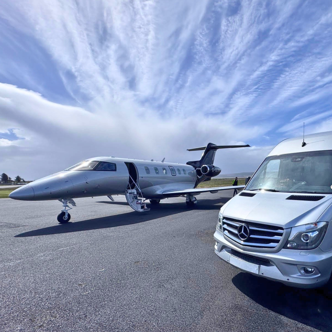 Private jet on tarmac next to private chauffeur