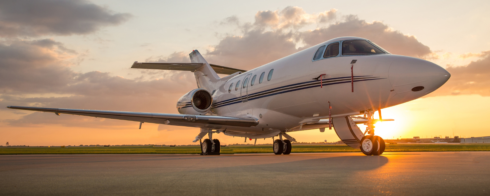 private jet on the ground at sunset