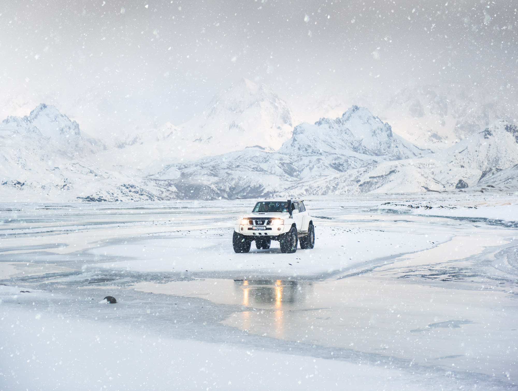Super jeep on snow in Iceland surrounded snow ice and snowy mountains