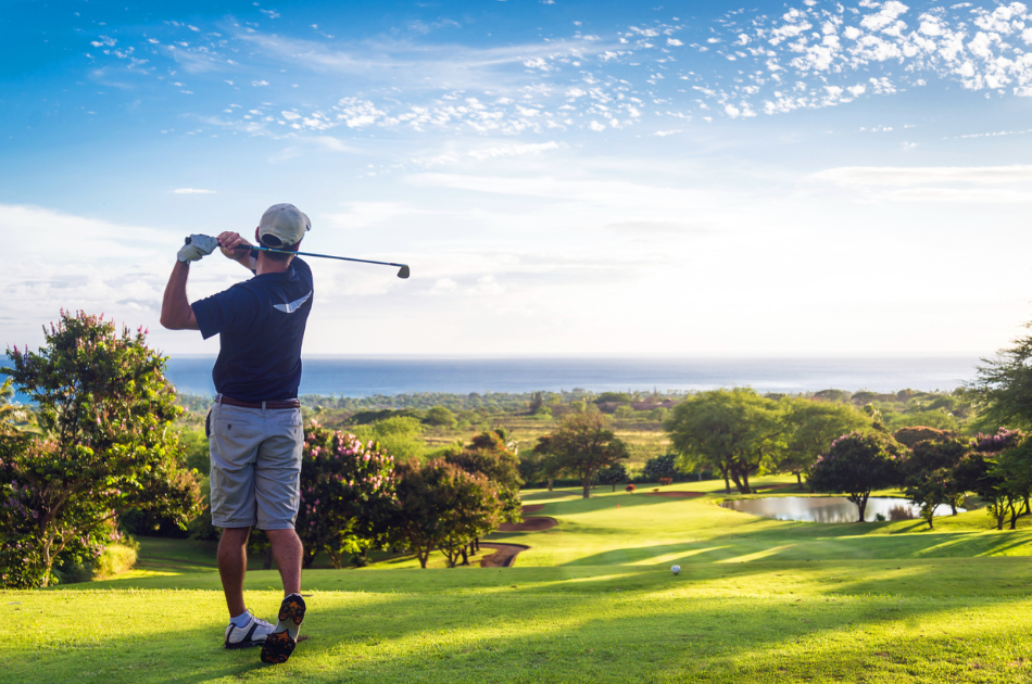 man playing golf on golf course in the sun
