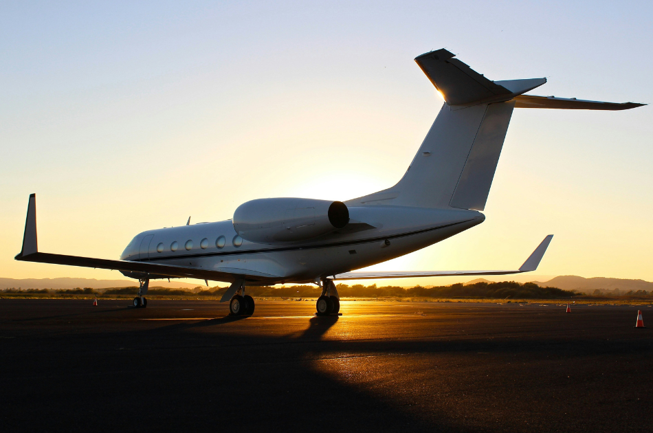 private jet on tarmac at sunset