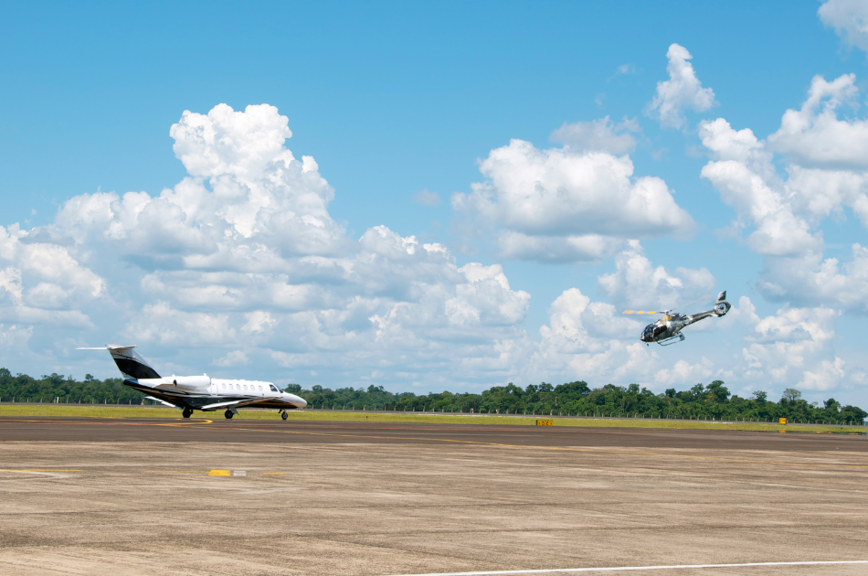 private jet and helicopter on tarmac