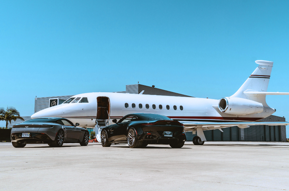 private jet and luxury sports car on tarmac at airport
