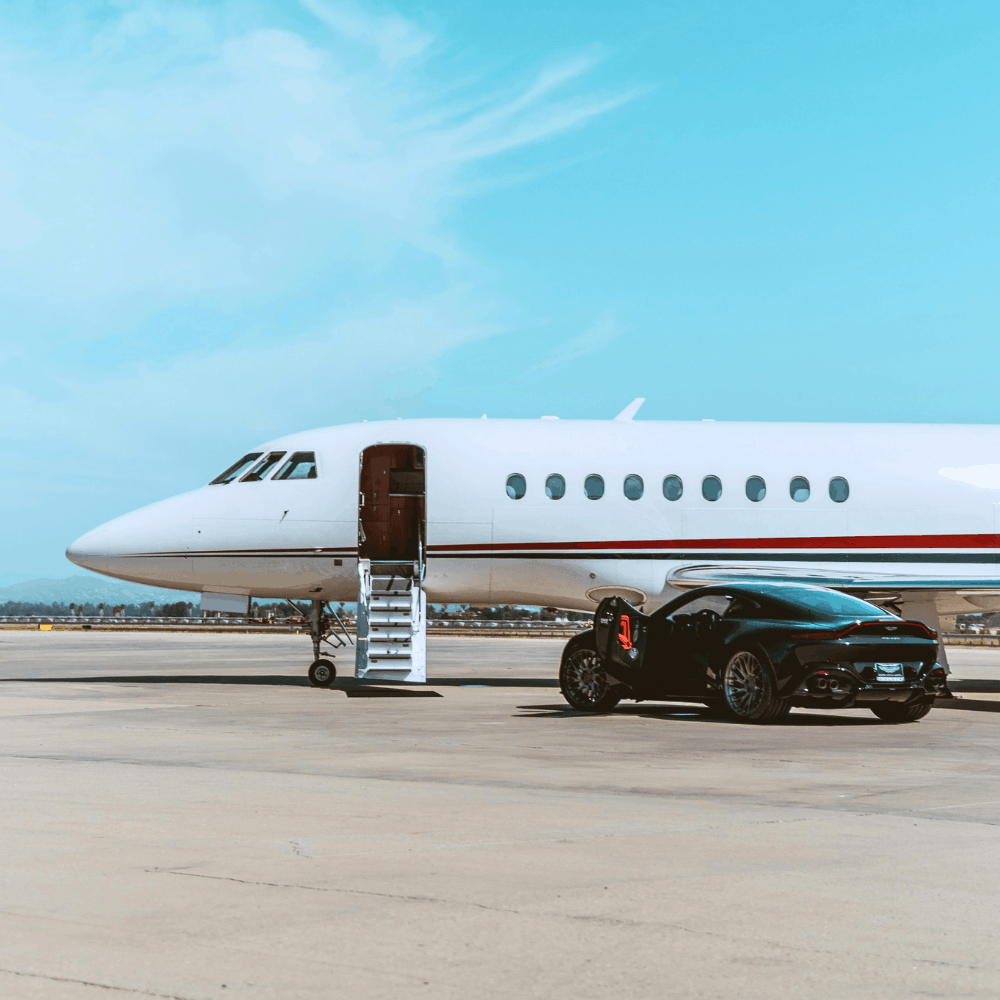 sports car in front of private jet sitting on tarmac